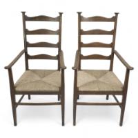 Liberty & Co., Style of C. F. A. Voysey. A Pair of Oak Rush Seat Ladderback Armchairs