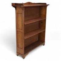 Wylie & Lochhead, attributed. An Arts & Crafts Oak Bookcase with Ying-Yang Detail to the Top & Adjustable Shelves