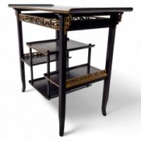 Heals. An Anglo-Japanese Ebonised Side Table with Gilt Fretwork & Flaring Ends