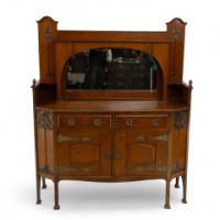 Liberty & Co., attributed. An English Arts & Crafts Oak Sideboard with Carved Decoration
