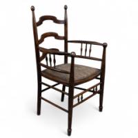 Liberty & Co., attributed. An English Walnut Arts & Crafts Ladder Back Armchair - Thumbnail 1