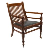 James Peddle, attributed. An Aesthetic Movement Oak Armchair with Serpentine Shaped Back