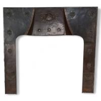 A Large Arts & Crafts Copper Fire Insert with a Lion in a Shield Crest