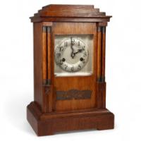 A Continental Arts & Crafts Oak Mantle Clock with Carved Stylised Glasgow Roses