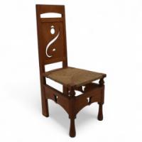 M. H. Baillie Scott, attributed. An Arts & Crafts Oak Chair with Stylized Floral Cut-outs