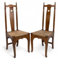 Shapland & Petter. A Pair of Arts & Crafts Oak Dining Chairs with Pierced Hearts