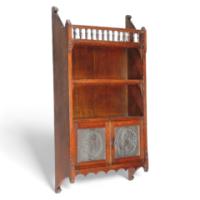 E. W. Godwin attributed. an Oak Hanging Bookcase, with Portrait Medallion Roundels in Moulded Vulcanite