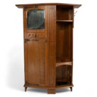 Shapland & Petter, attributed. An Arts & Crafts Oak Hall Cupboard with Flaring Cornice