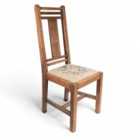 Liberty & Co., An Arts & Crafts Oak Chair with Carved Rose Decoration to the Back