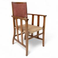 Liberty & Co., An Arts & Crafts Rush Seat Armchair with a Shaped Back