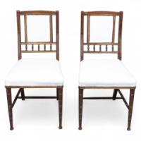 Bruce Talbert (1838-1881) Probably for Gillows of Lancaster & London. A Pair of English Aesthetic Movement Walnut Dining Chairs