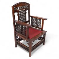 Liberty & Co., a Moorish Walnut Armchair with Mashrabiya Turned Details Throughout