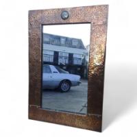 Liberty and Co. An Arts and Crafts copper mirror with a little blue Ruskin jewel to the top. - Thumbnail 1