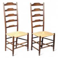 A pair of green stained ash and beech ladder back chairs, with re-rushed seats. - Thumbnail 1