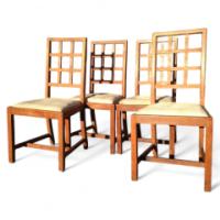 Heals of London. A set of four Arts and Crafts oak lattice back dining chairs - Thumbnail 1
