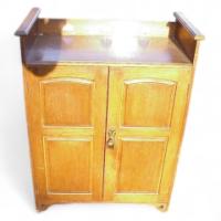 Wylie and Lochhead. An Arts and Crafts boot oak cupboard - Thumbnail 1