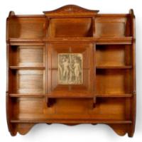 An oak hanging bookcase with open shelves placed around a central door - Thumbnail 1