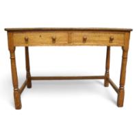 Heals of London. An oak Arts and Crafts Cotswold style two drawer desk - Thumbnail 1