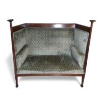 Walter Cave, an Arts & Crafts Oak Settee with Voysey Style Uprights