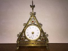 Bruce Talbert. A Reformed Gothic brass triform mantel timepiece - Thumbnail 1
