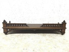 A Gothic Revival walnut wall shelf with carved foliate details - Thumbnail 1