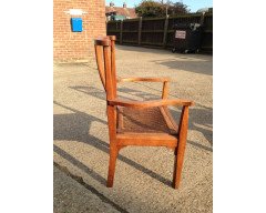 Arthur Simpson. An armchair with shaped back and original ratten drop - Thumbnail 4