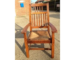 Arthur Simpson. An armchair with shaped back and original ratten drop - Thumbnail 9