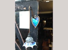 A pair of Arts and Crafts copper wall lights with peacock blue enamel heart shaped back plates. - Thumbnail 1