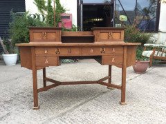 G M Ellwood for J S Henry. An Arts Crafts oak desk inlaid with stylised floral panels - Thumbnail 1