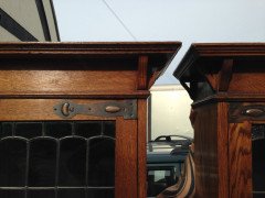 A pair of Arts and Crafts oak glazed bookcases over a lower cupboard - Thumbnail 4
