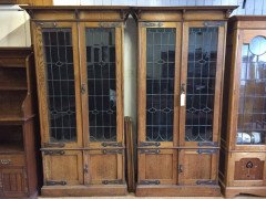 A pair of Arts and Crafts oak glazed bookcases over a lower cupboard - Thumbnail 8