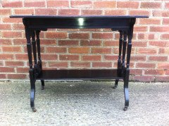 An ebonised oblong sidetable with subtle carved details - Thumbnail 2