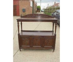 A Gothic Revival oak buffet with stylised floral carving to the top - Thumbnail 1