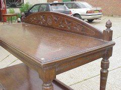A Gothic Revival oak buffet with stylised floral carving to the top - Thumbnail 3
