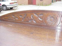 A Gothic Revival oak buffet with stylised floral carving to the top - Thumbnail 4