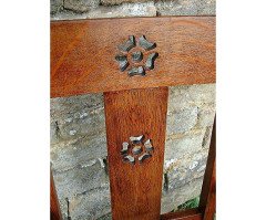 An Arts and Crafts Cotswold School armchair with lower shelf and pierced floral detail - Thumbnail 3