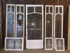 A set of stained glass doors and windows, riddled with intricate floral detailing. - Thumbnail 1